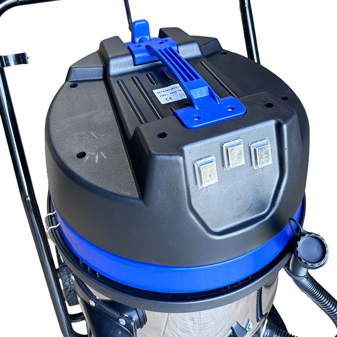 Close-up of the top of the Classic Cyclone with black and blue motor head, three toggle switches, and ergonomic handle.